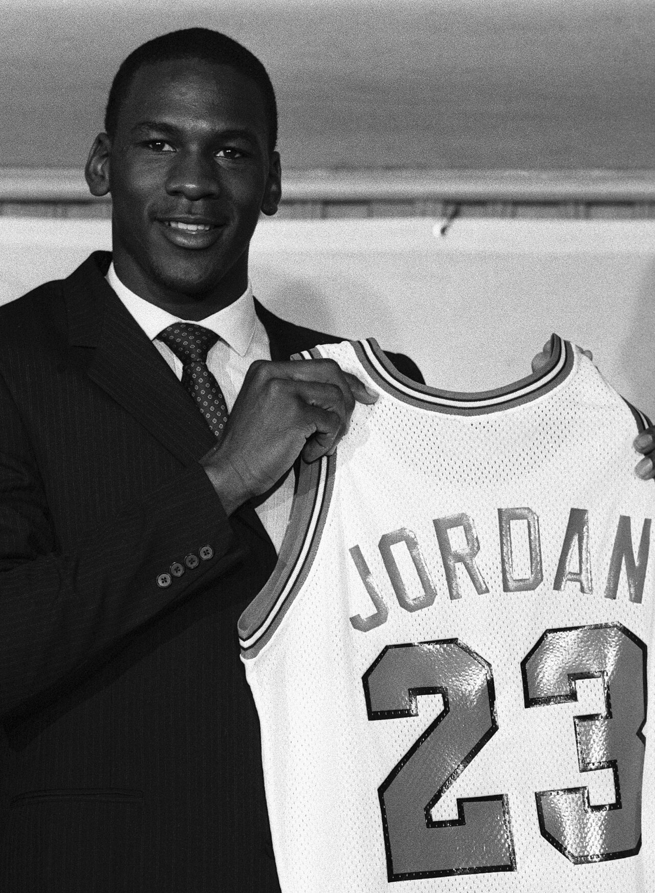 Michael Jordan — Michael Jordan holds up his Chicago Bulls jersey on September 12, 1984